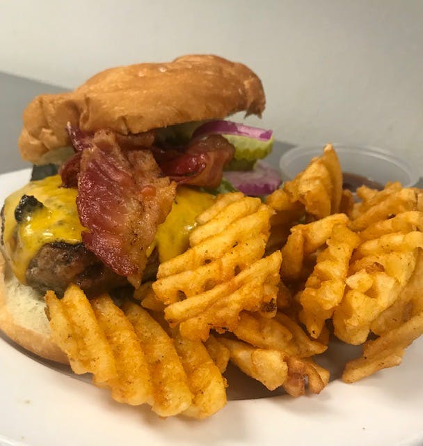 a close up of a sandwich and fries on a plate